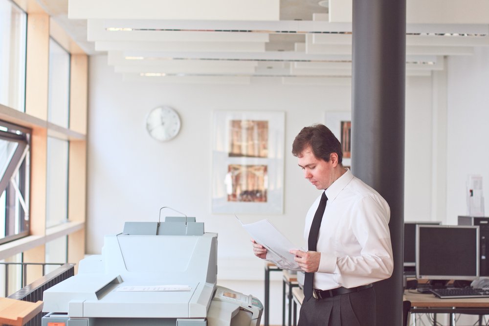 office technology solutions TOPS Office | Toner Fulfillment Service | Man using copier in office