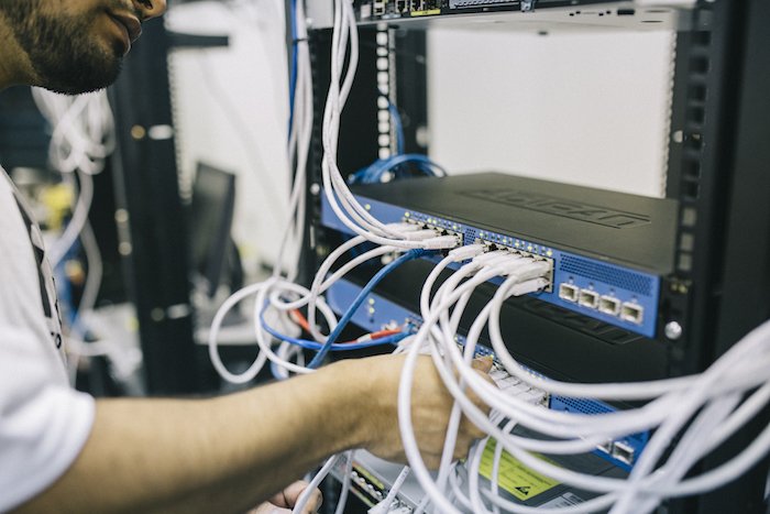A computer technician setting up a VLAN network inside of a local business