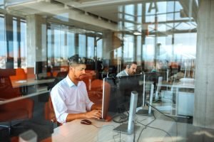 office technology solutions A group of professionals working in a large business all talking on phones