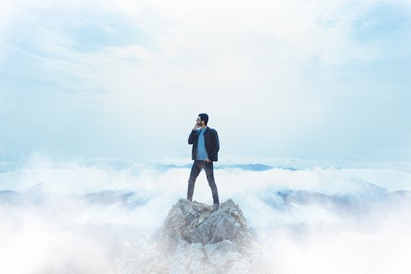 A business man standing in the clouds, representing cloud computing and storage services